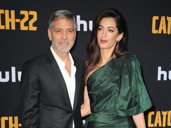 Jorge. loco a la izquierda en un traje. Amal Clooney a la derecha con un vestido verde, juntas en el estreno de una película.