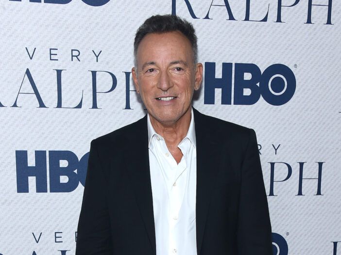 Bruce Springsteen takım elbise içinde gülümsüyor
