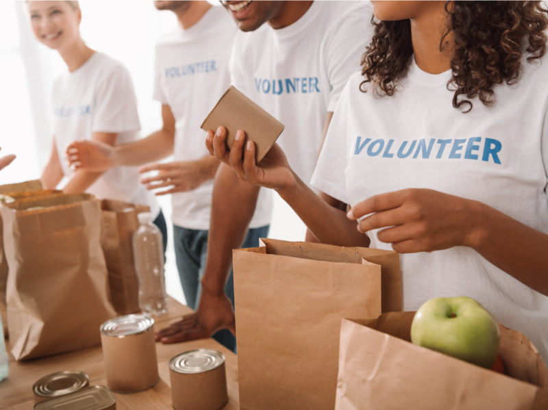 En gruppe frivillige pakker bokser med mat på en mattur